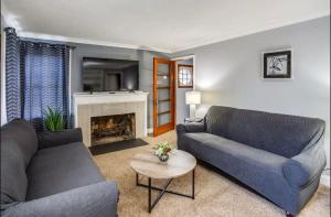 a living room with two couches and a fireplace at Astonishing Home Mins Away Airport Dwtn UofR andRIT in Rochester