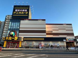 a building with a sign on the side of a street at CRYSTAL & RESORT Exclusive in Fukuoka