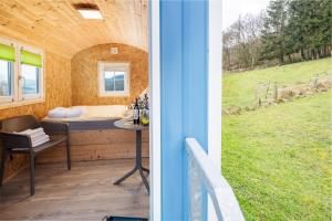 a room with a table and a bed and a window at Bollendorf Eifel Nature in Bollendorf
