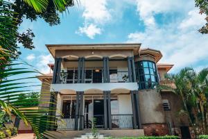 a large house with a balcony on top of it at Affordable Homely Apartment 2 in Namulanda