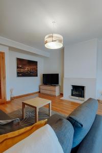 a living room with a couch and a table at Sweet living Porto in Valbom
