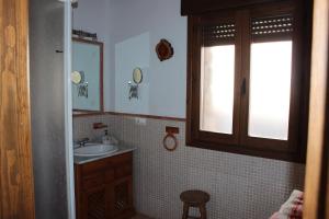 un bagno con lavandino e specchio di La Chimenea de Soria I y I I a Espeja de San Marcelino Altre 51 foto