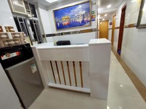 a white counter in a room with a tv on the wall at Rhine Guest House in Hong Kong