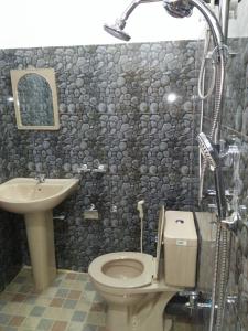 a bathroom with a toilet and a sink at Kelani Riverside Retreat in Kitulgala