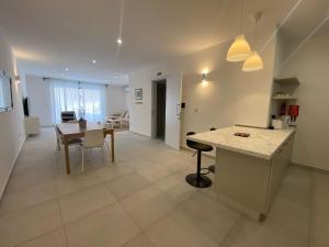 a kitchen and dining room with a table and a dining room at Swieqi Malaika New Apt 2 with COURTYARD in Is-Swieqi