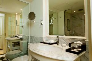 
a bathroom with a sink, toilet and bathtub at The Kingsbury Colombo in Colombo

