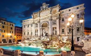a building with a fountain in front of it at night at Interno 1 Ciampino Roma Luxury Apartment con balcone in Ciampino