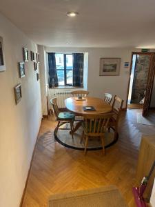 a dining room with a wooden table and chairs at Cranstakie Cottage in Durness