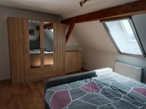 a bedroom with a bed and a wooden cabinet at Ferienwohnung Schack in Bodensdorf