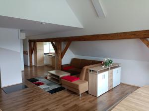 a living room with a couch and a table at Ferienwohnung Schack in Bodensdorf +16 photos
