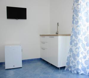 a kitchen with a sink and a counter top at Aurora B&B in Agropoli