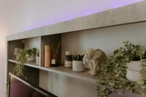 a shelf with plants and a statue of an elephant at Stylish Stonehouse in Platres in Platres