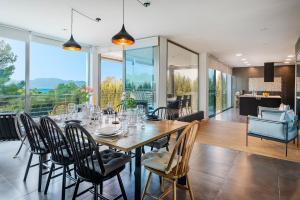 a dining room with a table and chairs at Villa Rockstar, Alcudia - by EMERALD STAY in Alcudia