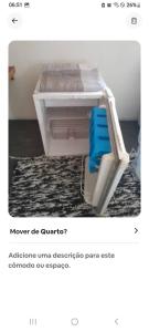 a picture of a white desk with a blue chair at Suíte afastada do Centro, na mata in Itacaré +3 photos