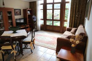 a living room with a couch and a table at Apartamentos La Pontiga *** in Infiesto