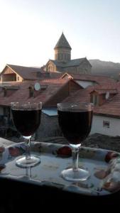 two glasses of red wine sitting on a table at Guesthouse Mtskheta-Kapanadze in Mtskheta