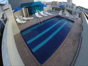 a swimming pool on the roof of a building at Flat próximo ao Shopping e Praia in São Vicente