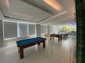 a room with two ping pong tables in it at Flat próximo ao Shopping e Praia in São Vicente