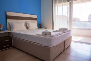 a bedroom with a large bed with towels on it at Vila Kalina Apartments in Sutomore