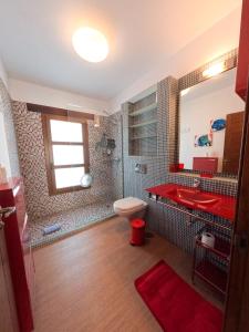 a bathroom with a red sink and a toilet at Villa Volcan2 Rural Private Pool la Oliva by Holidays Home in La Oliva