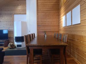 a wooden dining room with a wooden table and chairs at Kärpänrinne B in Syöte +27 photos