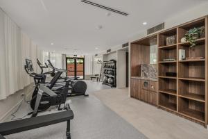 a gym with treadmills and ellipticals in a room at "The Mowbray"-Luxury,rooftop pool,gym,free parking in Brisbane