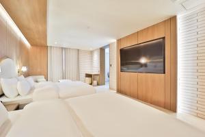 Rúm í herbergi á Hotel Ippda Gumdan