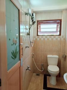 a bathroom with a toilet and a shower at Sajini Villa in Weligama +52 photos