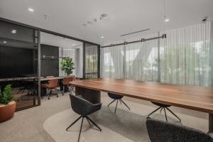 an office with a large wooden table and chairs at "The Mowbray"-Luxury,rooftop pool,gym,free parking in Brisbane +28 photos