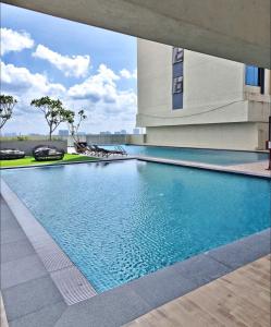 a swimming pool in the middle of a building at 3BR-Creamy-Paradigm Residence by Guesthouse-6-8Pax in Johor Bahru