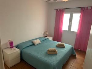a bedroom with a bed with two towels on it at Heavenly Homes Mojacar 4 in Mojácar