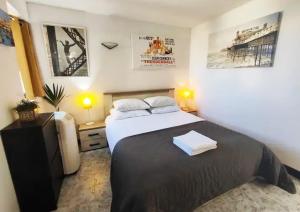 a bedroom with a bed with two towels on it at Epic 180 degree Sea & 3 Island Views Sun Terrace Penthouse in Qala
