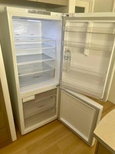 an empty refrigerator with its door open in a kitchen at Stylish Armadale Getaway in Armadale