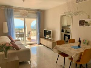 a living room with a couch and a table at Imperial Park - Bungalow mit Panoramablick und schöner Terrasse in Calpe
