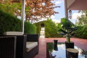 a patio with a table with a potted plant at Large Veranda 2BR Walk to Beach in Paralimni