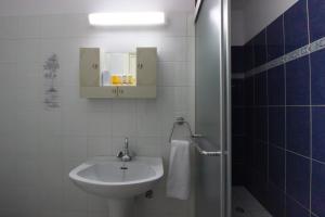 a white bathroom with a sink and a mirror at Large Veranda 2BR Walk to Beach in Paralimni +22 photos
