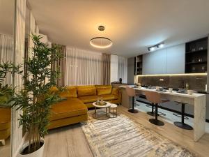 a living room with a couch and a table at LuxeVibe Apartments near Mall Moldova in Iaşi