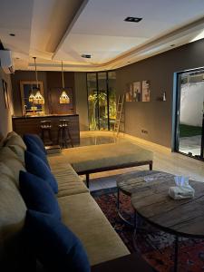 a living room with a couch and a table at Cali chalets in Riyadh