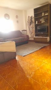a bedroom with a bed and a wooden floor at O Sitio da Paz in Robalo
