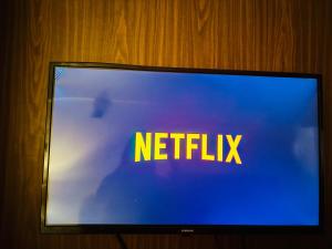 a television screen with the words netflix on it at Dun Haven Height in Dehradun