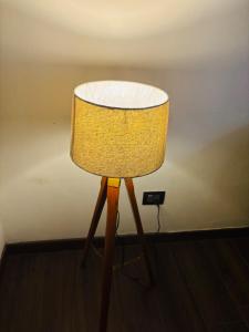 a yellow lamp sitting on top of a wooden table at Dun Haven Height in Dehradun