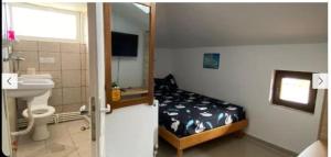 a bathroom with a bedroom with a bed and a sink at Vila Masy in Costinesti +10 photos