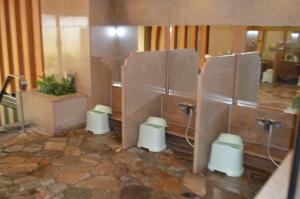 a bathroom with three toilets in a room at Aeria Tohno in Tōno