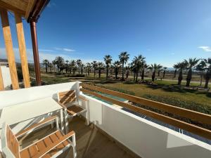 a balcony with chairs and a view of the beach at Pensión La Ola in Grao de Castellón