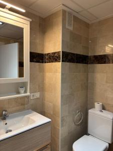 a bathroom with a sink and a toilet and a mirror at Heavenly Homes Mojacar 4 in Mojácar +29 photos