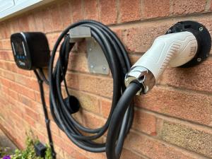 a hair dryer is attached to a brick wall at Cosy Studio Near Park and Town in Bromsgrove