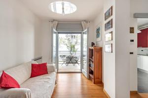 a living room with a couch and a kitchen at Private Condo Terrace & Parking in Rome +12 photos