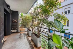 a balcony with plants and a table on it at Private Condo Terrace & Parking in Rome