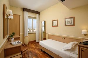 Postel nebo postele na pokoji v ubytování Hotel Santa Costanza by OMNIA hotels