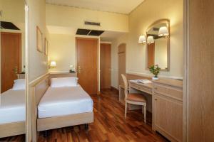 Postel nebo postele na pokoji v ubytování Hotel Santa Costanza by OMNIA hotels